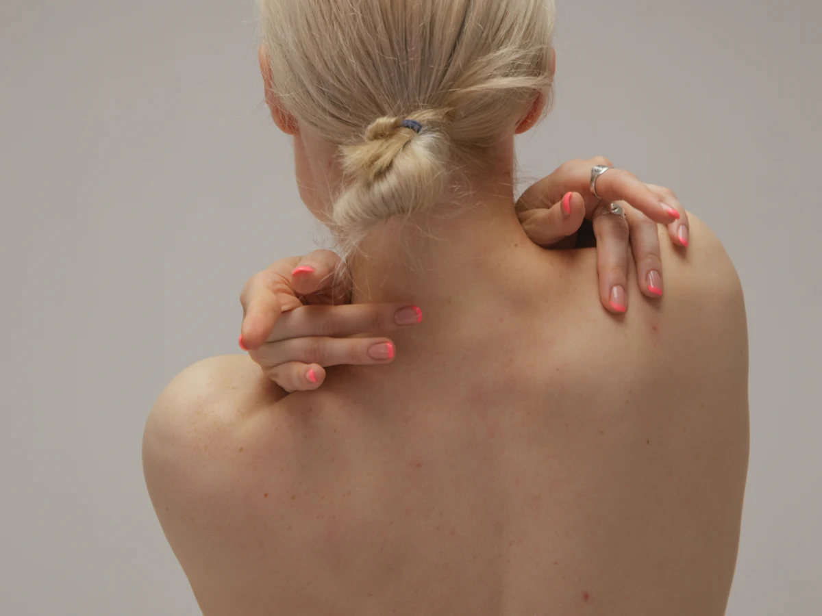 Person sitting with head in hands, living with long-term chronic pain
